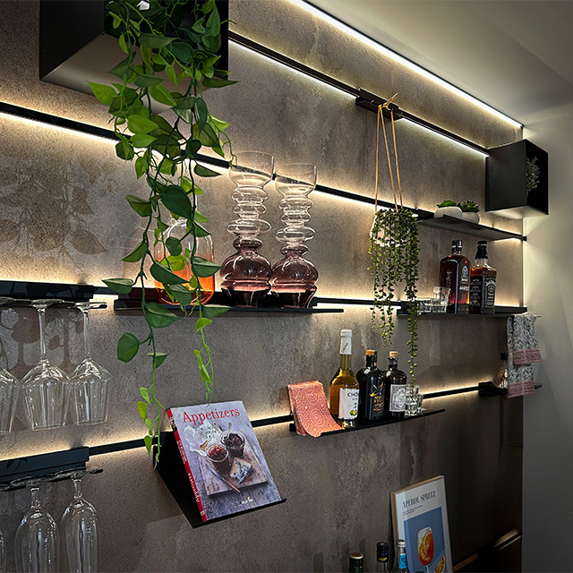 A modern splashback with lighting, shelves and decorative features, ideal for stylish kitchens